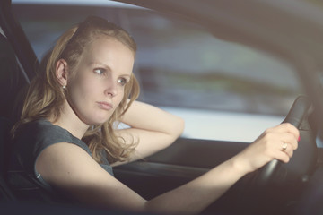 Fototapeta na wymiar Lonely woman drives a car