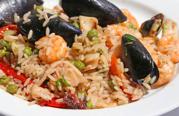 paella rice with mussels and shrimp and green peas
