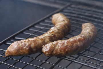 beautiful delicious sausages on charcoal