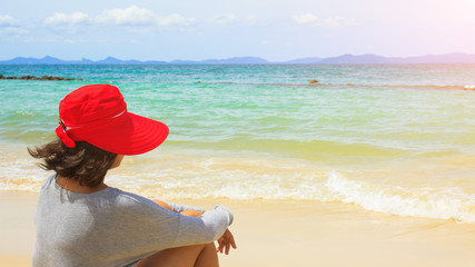 Lonely girl sitting on the beach