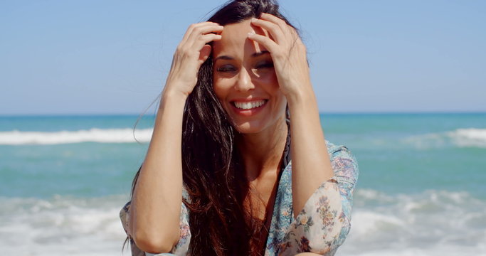 Happy Woman at the Beach Looking at Camera