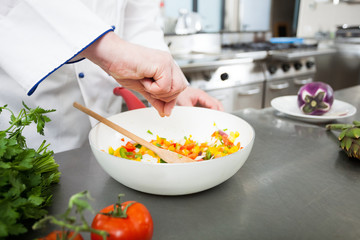Chef spicing a dish