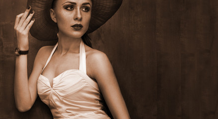 beautiful woman in hat with red lips posing before camera