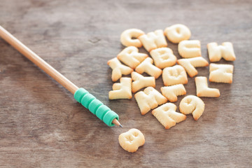 Alphabet biscuit on wooden table