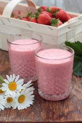 Two glasses of freshly prepared, delicious strawberry milkshake.