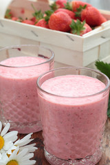 Two glasses of freshly prepared, delicious strawberry milkshake.