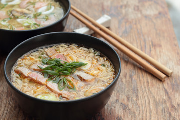 Bowl of oriental noodle and pork soup.