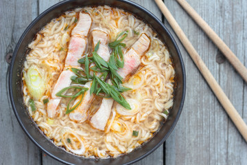 Bowl of oriental noodle and pork soup.