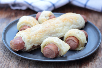 Wiener sausage in french pastry on a tin plate.