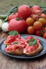Three pieces of bruschetta on a tin plate.