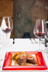 Rolled and stuffed meat with vegetables in restaurant