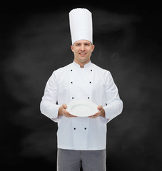 happy male chef cook showing empty plate