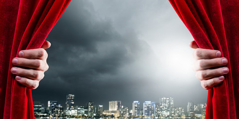Close up of hand opening red curtain