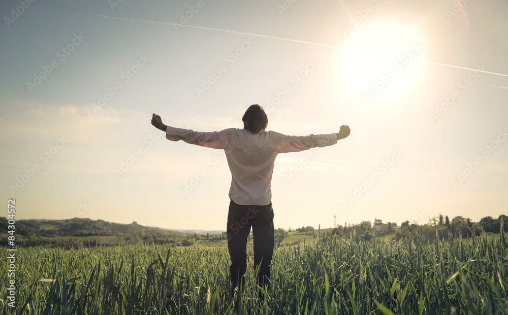 Wall mural happy man facing the sun