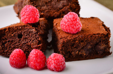 Home made chocolate brownies and raspberries.