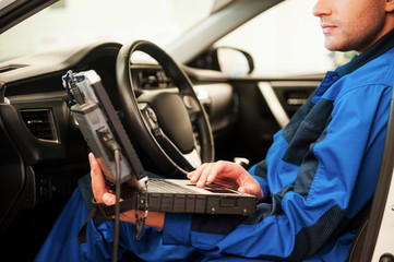 Man examining car. 