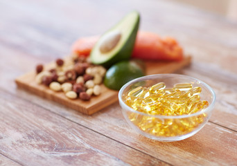 close up of omega 3 capsules and food on table