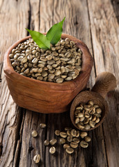 green coffee beans in wooden bowl