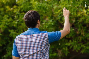 man back writing hand in the air on a green background street tr