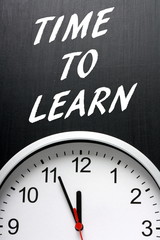 The phrase Time To Learn on a blackboard with a clock