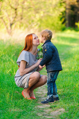 Fototapeta premium Son presented to mum flowers