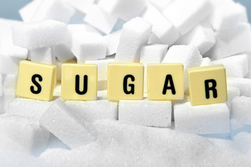 sugar block letters word on pile of sugar cubes close up