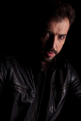 Obraz premium young man posing on dark studio background.