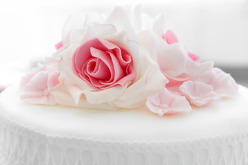 White wedding cake with pink rose