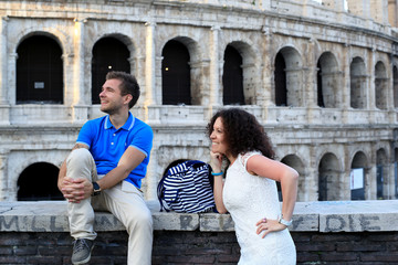Naklejka premium Tourists on the background of the Colosseum, Roman holiday