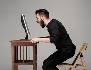 Funny and crazy man using a computer