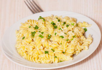 fusilli pasta in a creamy sauce.