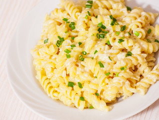 fusilli pasta in a creamy sauce.