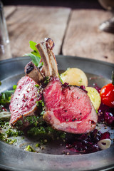 Tasty rustic dinner of lamb cutlets and salad