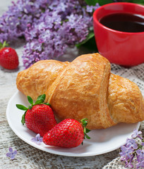 Breakfast with croissant, strawberry and coffee