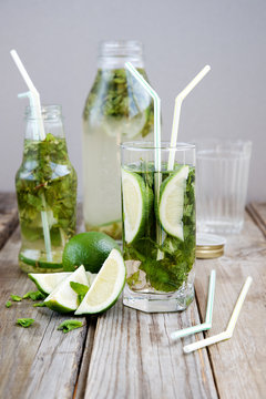 Lemonade with mint and lime on an old wooden table 