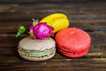 flowers and macaroons  on wooden background