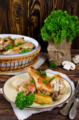 Baked chicken legs with potatoes, champignon and cauliflower