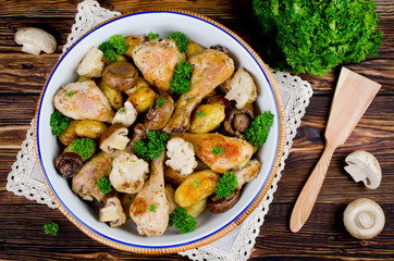 Baked chicken legs with potatoes, champignon and cauliflower