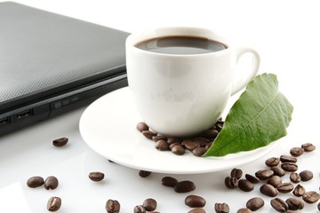Cup of coffee with laptop at breakfast