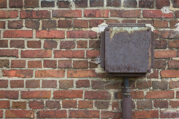 aged red brick wall texture background , electricity box
