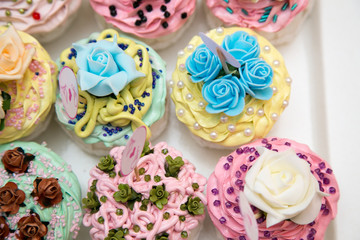 Fototapeta na wymiar Cupcakes And Macarons On A Tray As A Wedding Gift 