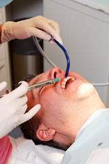 local anesthesia with syringe between the teeth