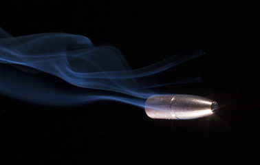Bullet with blue smoke behind