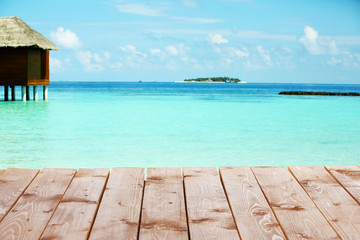 View of beautiful blue ocean water and bungalows in Baros Maldives