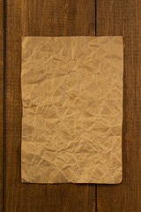 wrinkled note paper on wood