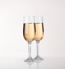 Two glasses of champagne over light gray white background