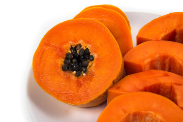 Isolated ripe papaya in the white dish