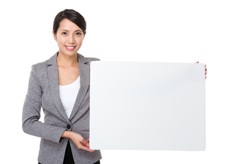 Young businesswoman show with white poster