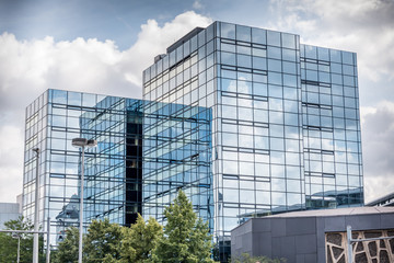 Glass building with clouds reflection