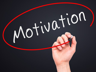 Man Hand writing Motivation with marker.